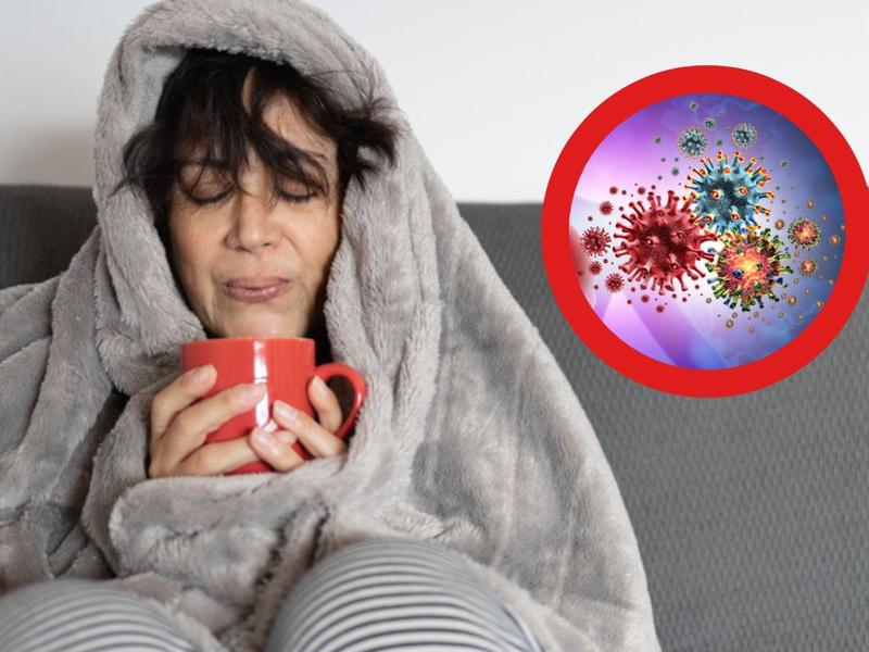 Mujer sosteniendo taza roja se pregunta cuánto tiempo tarda en curarse una gripe, ilustración de virus