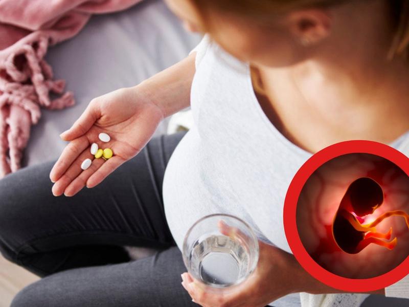 Mujer sosteniendo medicamentos prohibidos en el embarazo, ilustración de feto