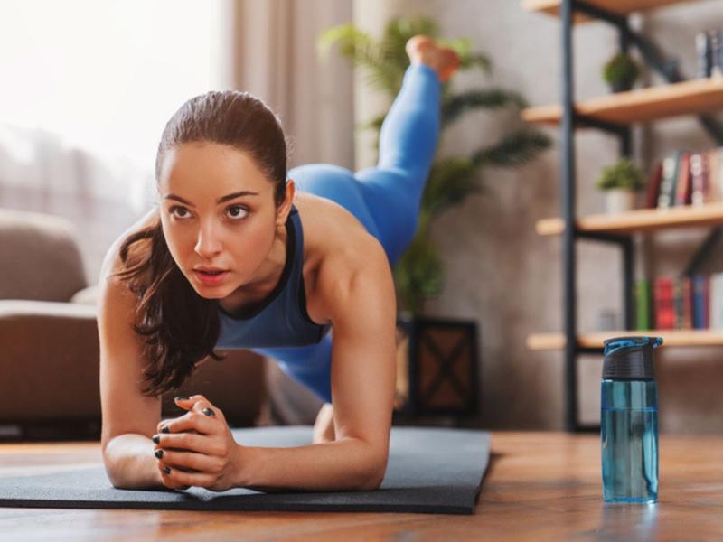 Mujer haciendo postura de yoga para explicar cuántos kilos puedes perder con yoga