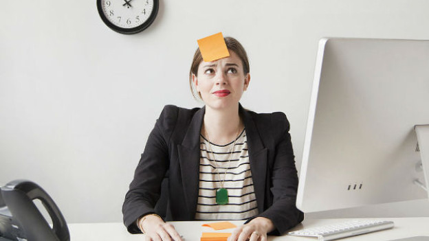 Mujer con un papel en la cabeza para recordar sus actividades. Foto iStock