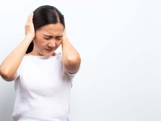 Mujer con los oídos tapados muestra por qué se tapan y destapan los oídos