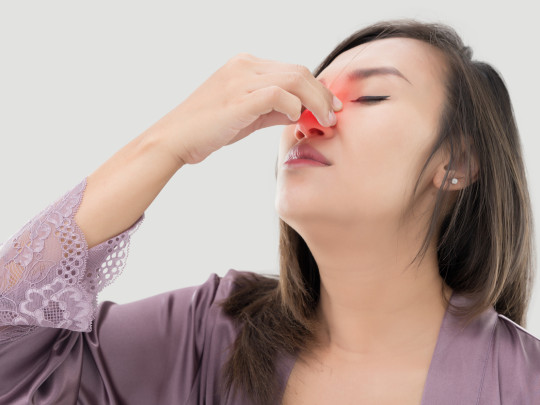 Mujer con ardor en la nariz por gripe